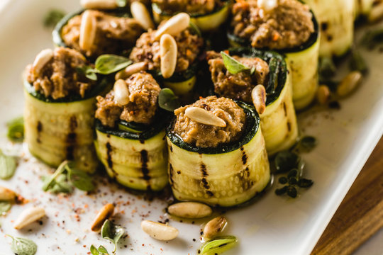 vegan appetizer of grilled zucchini and olive pate on a festive table. healthy food for a family or a party