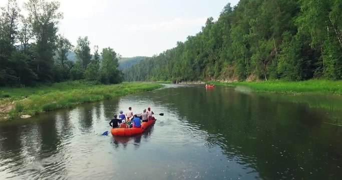 Epic Rafting Two Orange Boat on Shallow Mountain Forest Zilim River in Ural Mountains, Russia at summer sunny day - Aerial view