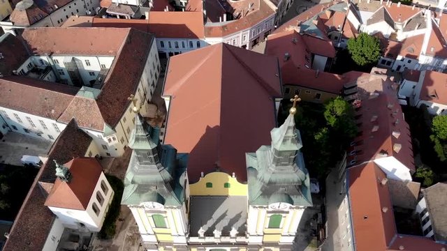 Ascending and turning aerial shot of a duel towered church