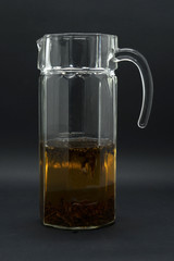 Tea in a glass jar isolated in black background
