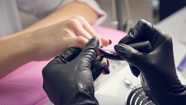 Painting gel polish on female nails