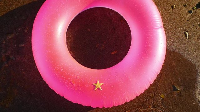 Starfish on the pink inflatable circle