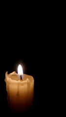 Obraz na płótnie Canvas Burning candle in the dark 1. Black background. Isolated