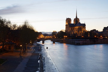 Paris, France - April 3, 2018: Notre dame de Paris cathedrale viewed from Tournelle bridge at dusk