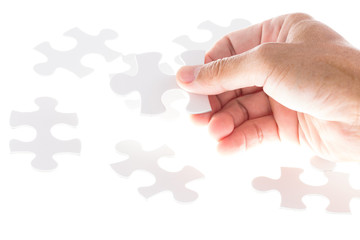 Man hand holding jigsaw puzzle