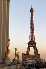 Fototapeta na wymiar PARIS - FRANCE, NOVEMBER 7, 2017: Eiffel Tower and Golden Statue from Tracadero Square at dusk. The Eiffel tower is the most visited monument of France