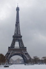 Fototapeta na wymiar Paris, France - February 7, 2018: Eiffel tower and champs de mars covered with snow