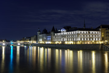 Paris, France - February 18, 2018: View of the Conciergerie on the Ile de la Cite in Paris by night from Pont neuf bridge