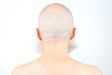 portrait of bald man with beard from back on light background