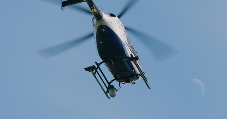 Police helicopter lifting off to fly out on police operation. 