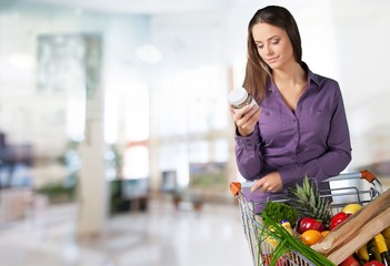 Woman with cart shopping in supermarket © BillionPhotos.com