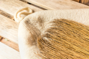 Yellow broom lies on a white hat in a bath