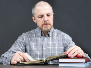 man ponders reading a Bible book