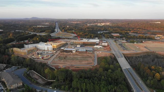 Flying over new mall construction next to condos and highway in Atlanta Suburbs