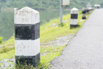 Close up of Black and white milestone with green grass.