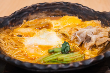 Close up of nabe kimchi soup with tofu vegetable and meat.
