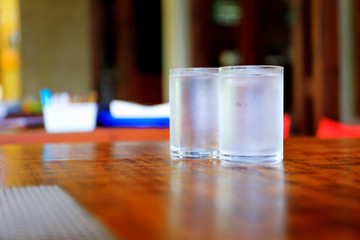 glass of water on wooden table in the morning