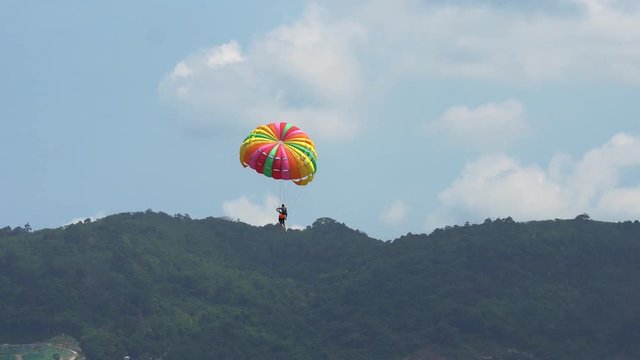 The tourist Flying on a parachute at patong beach