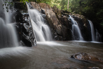 Fototapeta premium Water of the stream in the natural, Beautiful waterfall in forest.
