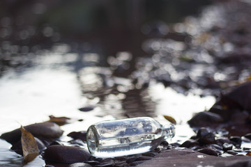 Glass bottle in the river. Form negligence people.