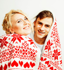 young pretty teenage couple at Christmas time warming in red dec