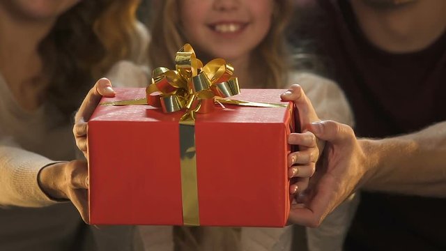 Family showing giftbox, charity event for Christmas, make present to orphan