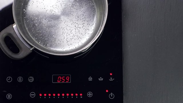 Boiling water in metal pan, closeup