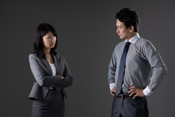 対立するビジネスマンとビジネスウーマン
