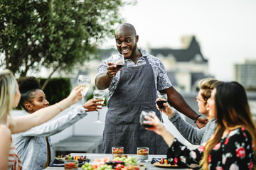 Friends toasting with the chef at a summer party