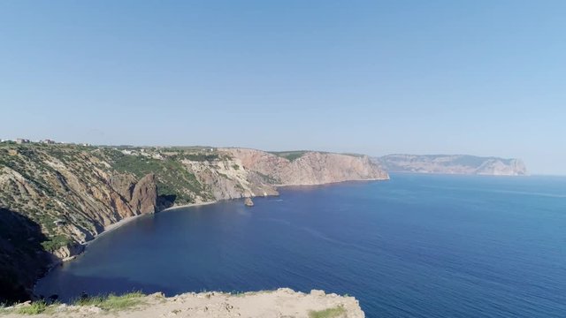 Moving between plastic chairs and flying above chancel prepared for wedding placed on high top cape above sea. Fiolent cape, Sevastopol, Crimea