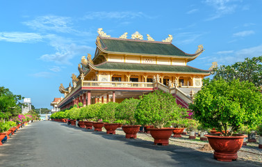 Fototapeta premium Vung Tau, Vietnam - September 30th, 2018: Architecture presbytery temple Dai Tong Lam afternoon sunshine, which attracts tourists to visit spiritually and relax soul on weekends in Vung Tau, Vietnam