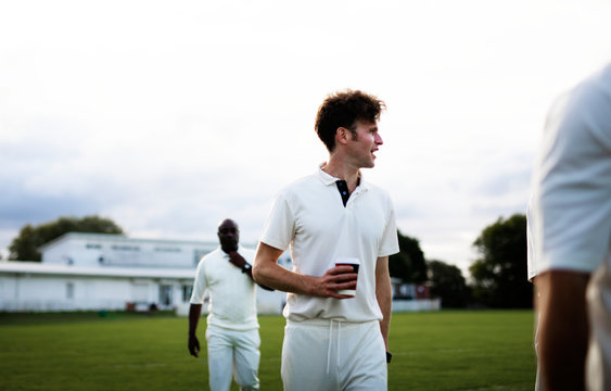 Cricket player holding a coffee paper cup - Powered by Adobe