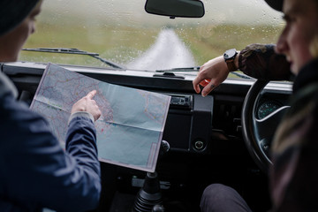 Couple on a road trip checking the map
