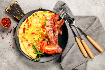 Omelet with vegetables and bacon.