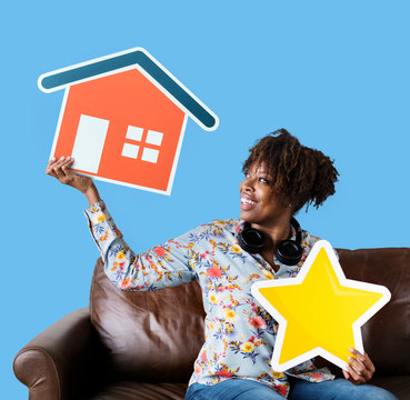 Cheerful woman holding a house and star icons