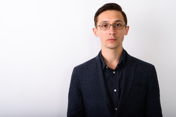 Close up of young handsome businessman wearing eyeglasses agains