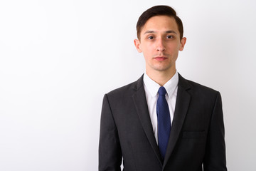 Portrait of young handsome businessman against white background