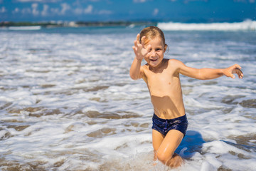 Fototapeta na wymiar boy playing on the beach in the water