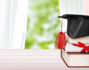 Graduation cap with books  and Degree