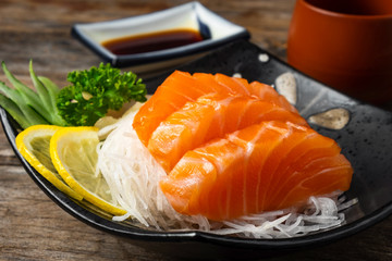 Sashimi, Salmon, Japanese food chopsticks and wasabi on the  table