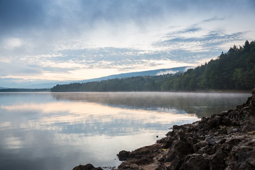 Morning view on foggy Shaori Lake at sunrise Georgia country