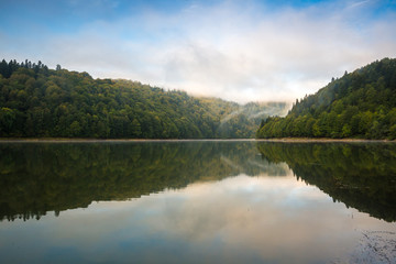 Morning view on foggy Shaori Lake at sunrise Georgia country