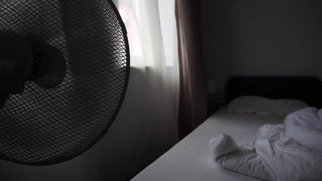 Electric Fan Blowing Air On In Hotel Bed Room