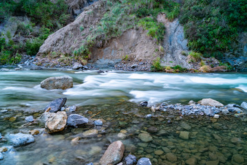 Fototapeta na wymiar Water rushing over rocky bottom of Rangatikei River