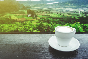 coffee cup on table with Mountain views in the morning as a background