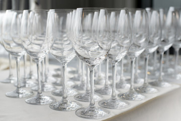 A lot of wine glasses in a row