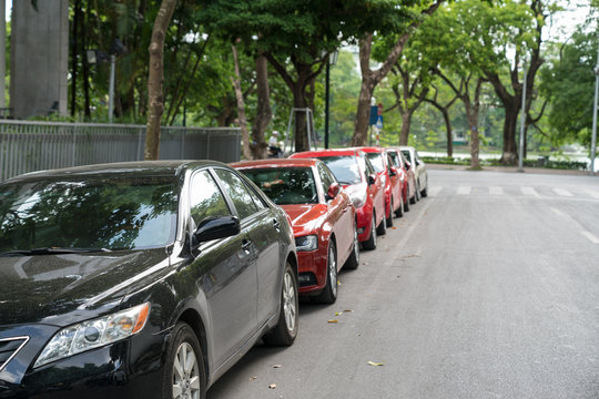 Parallel parking cars on urban street. Outdoor parking on road