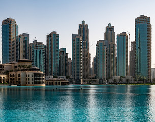 Fototapeta na wymiar Blue marina with skyscrapers, hot sunny afternoon.