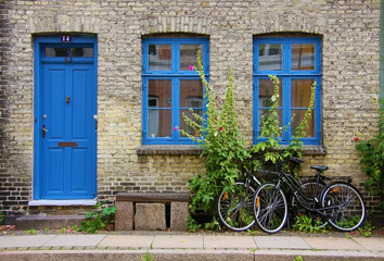 Colorful houses in Copenhagen, Denmark. Two bicycles parked near the wall of the old house.