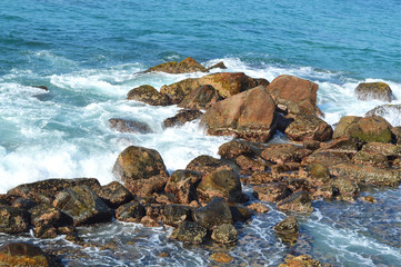 rocks on the shore of the Indian ocean at mirissa beach of the island of Ceylon